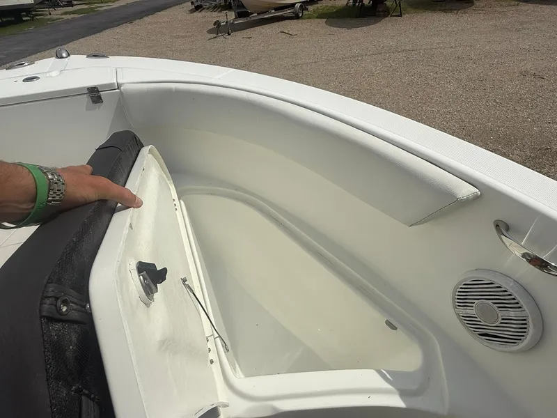 Slide: The Image of 2018 Clearwater 2200CC boat interior with open storage compartment and speaker. - 20