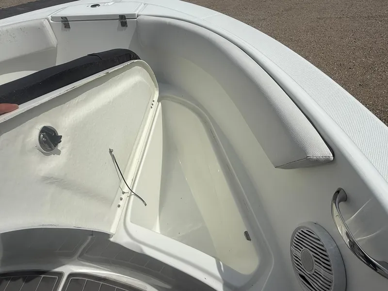 Slide: The Image of 2018 Clearwater 2200CC boat interior with storage compartment and speaker detail. - 21