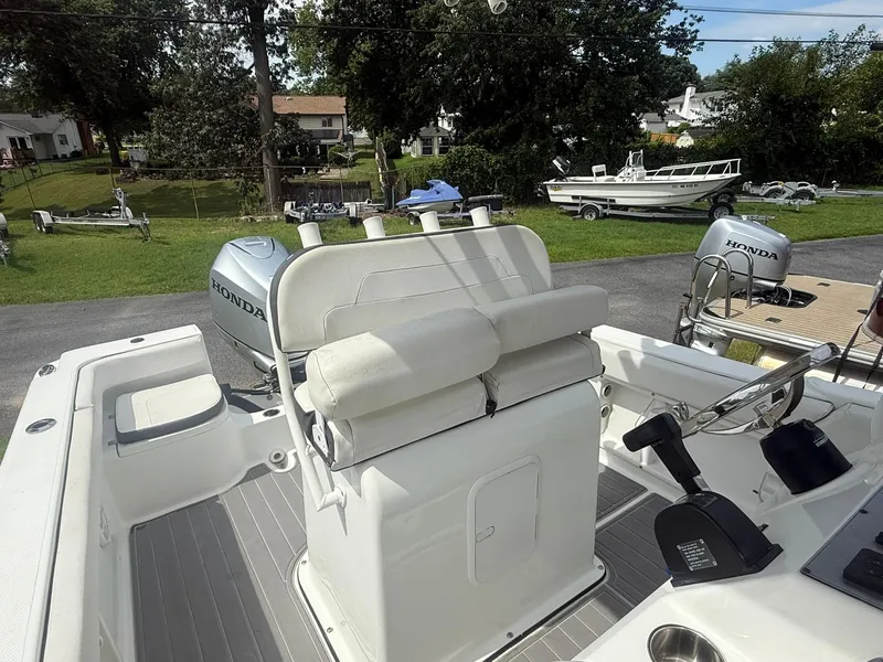 Slide: The Image of 2018 Clearwater 2200CC boat interior with Honda outboard motor, parked in a residential area. - 23