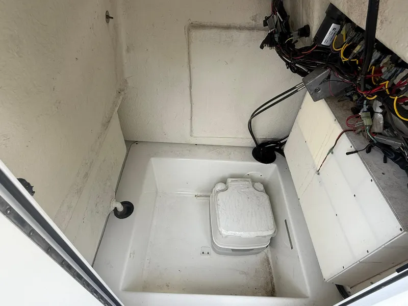 Slide: The Image of 2018 Clearwater 2200CC boat interior with wiring and storage compartment. - 24