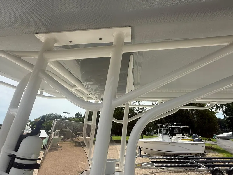 Slide: The Image of 2018 Clearwater 2200CC boat with T-top frame and nearby parked boats. - 25