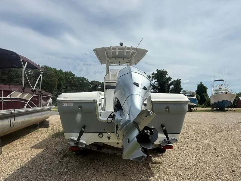 Slide: The Image of 2018 Clearwater 2200CC boat with outboard motor, parked on gravel lot. - 8