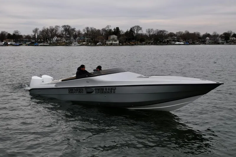 The Image of 2022 Velocity 290 SC speedboat, "Silver Bullet," cruising on a calm lake. - 1