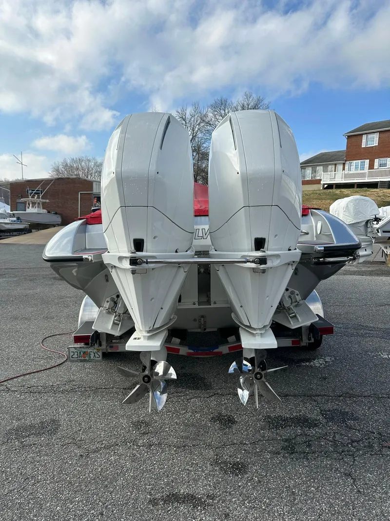 Slide: The Image of Rear view of 2022 Velocity 290 SC boat with dual outboard motors. - 12