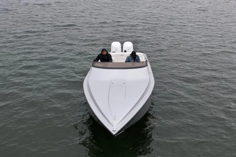 Slide: The Image of 2022 Velocity 290 SC boat on water, aerial view, two people onboard. - 2