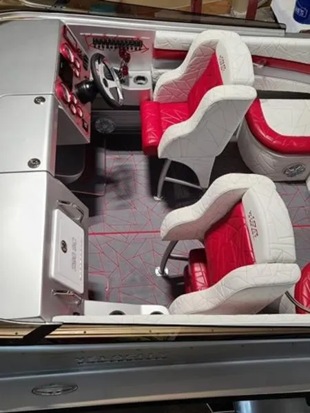 Slide: The Image of 2022 Velocity 290 SC boat interior with red and white seating and modern dashboard. - 3