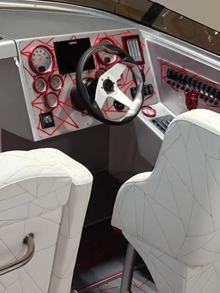 Slide: The Image of Interior of a 2022 Velocity 290 SC boat, featuring modern dashboard and white seating. - 5