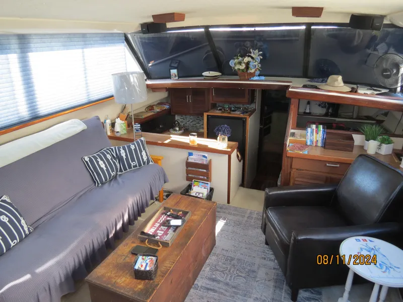 Slide: The Image of Interior of 1983 Silverton 40 Aft Cabin with cozy seating and decor. - 10