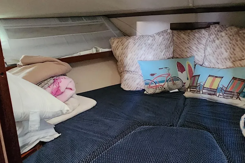 Slide: The Image of Cozy cabin interior of 1983 Silverton 40 Aft Cabin with decorative pillows and bedding. - 24