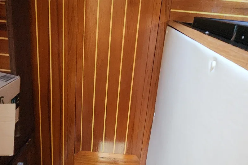 Slide: The Image of Interior of 1983 Silverton 40 Aft Cabin with wood paneling and white surface. - 25