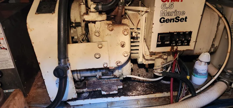 Slide: The Image of 1983 Silverton 40 Aft Cabin marine generator, Onan 6.5 Marine GenSet, in engine compartment. - 28