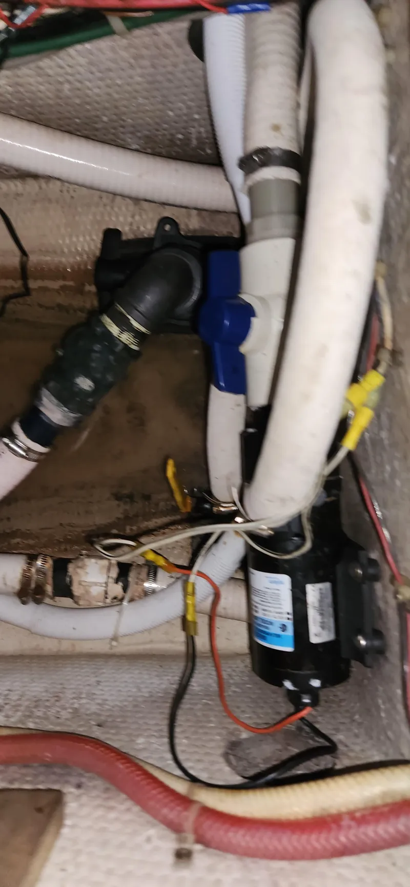 Slide: The Image of Engine compartment of 1983 Silverton 40 Aft Cabin with visible hoses and wiring. - 30