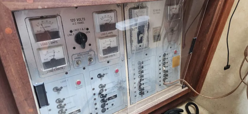 Slide: The Image of Electrical panel of a 1983 Silverton 40 Aft Cabin boat, showing gauges and switches. - 31