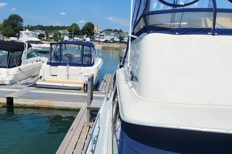 Slide: The Image of 1983 Silverton 40 Aft Cabin docked at a marina on a sunny day. - 7