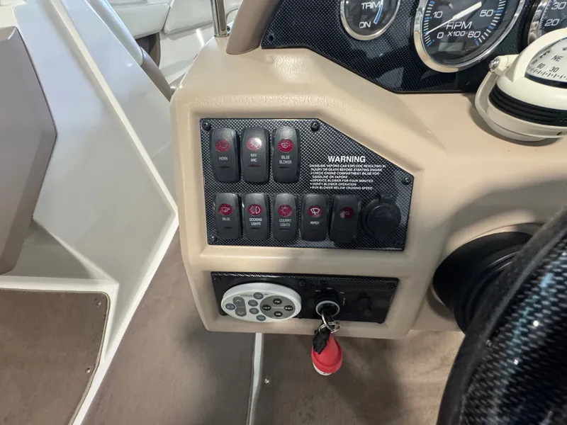 Slide: The Image of Control panel of a 2003 Regal 2200 boat with switches and gauges. - 10