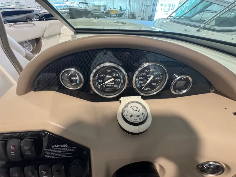 Slide: The Image of Dashboard of a 2003 Regal 2200 boat with gauges and compass. - 11