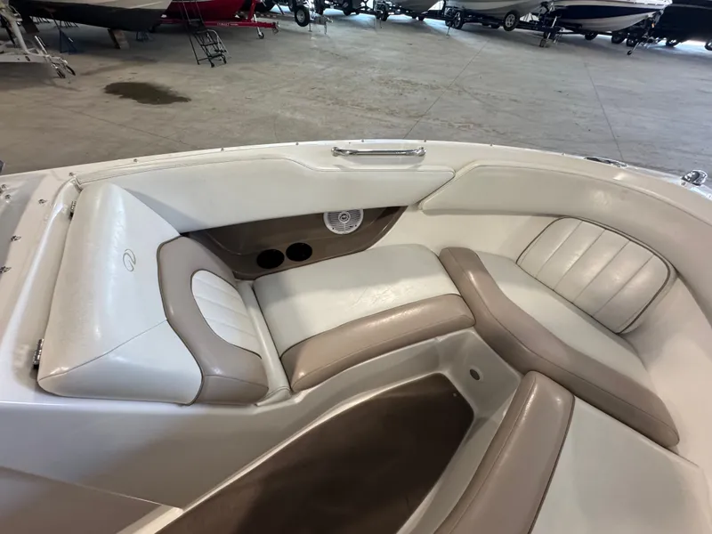 Slide: The Image of Interior seating of a 2003 Regal 2200 boat, featuring beige and white upholstery. - 12