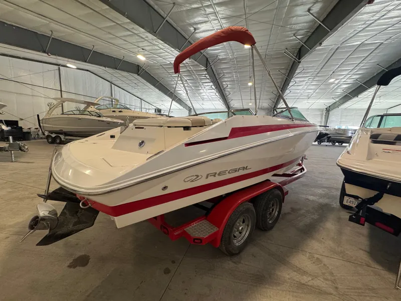 Slide: The Image of 2003 Regal 2200 boat on trailer in indoor storage facility. - 3