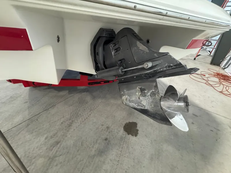 Slide: The Image of 2003 Regal 2200 boat stern with propeller and outdrive in a garage setting. - 4