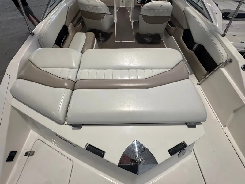 Slide: The Image of Interior of a 2003 Regal 2200 boat with beige and white seating. - 5