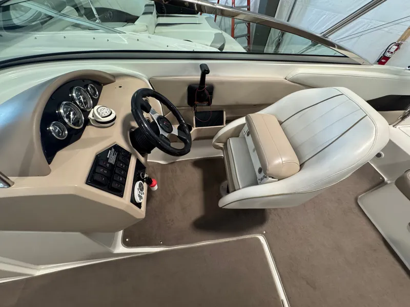 Slide: The Image of Interior of a 2003 Regal 2200 boat showing steering wheel and dashboard controls. - 8