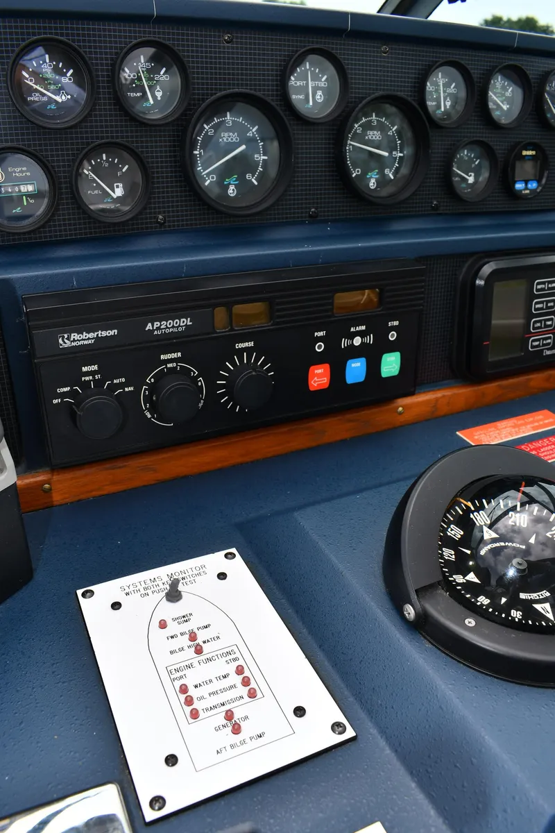 Slide: The Image of Dashboard of 1989 Sea Ray 390 Express Cruiser with gauges and navigation controls. - 17