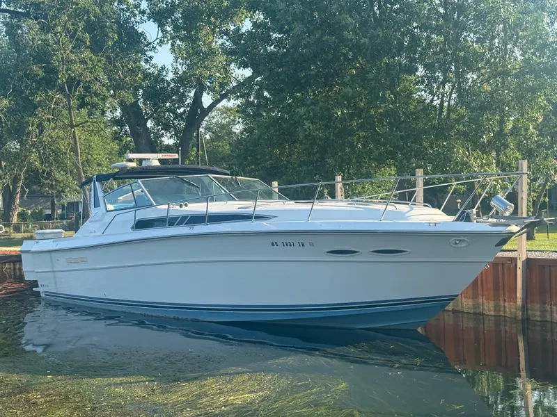 Slide: The Image of 1989 Sea Ray 390 Express Cruiser docked by trees. - 2