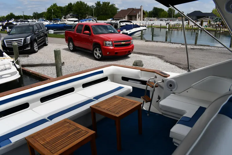 Slide: The Image of 1989 Sea Ray 390 Express Cruiser docked, with red truck and marina in background. - 22
