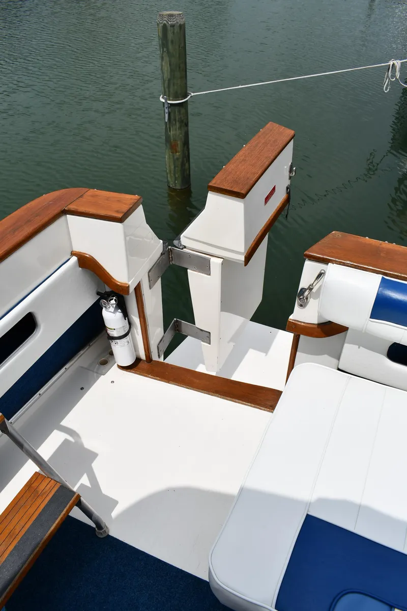 Slide: The Image of 1989 Sea Ray 390 Express Cruiser deck with wood accents and blue seating. - 28