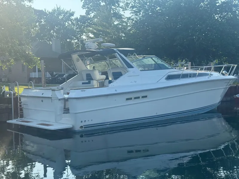Slide: The Image of 1989 Sea Ray 390 Express Cruiser docked on calm water. - 3