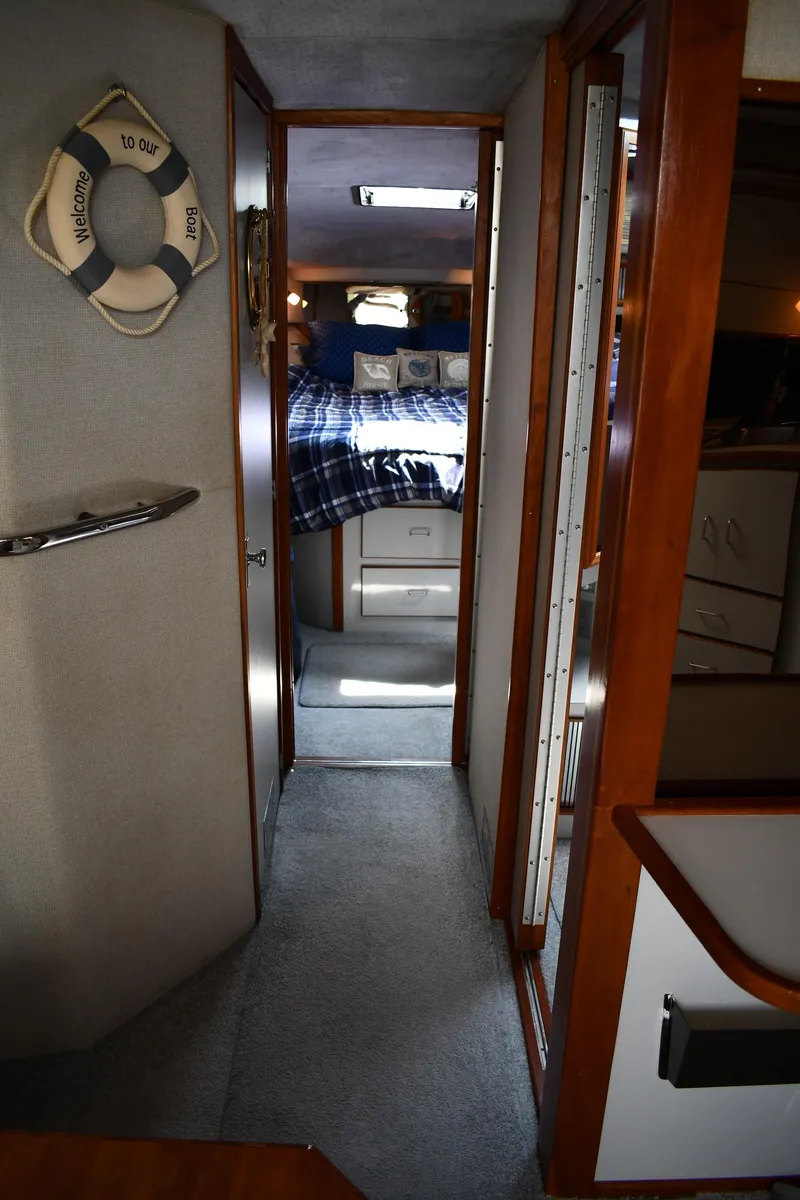 Slide: The Image of Interior of 1989 Sea Ray 390 Express Cruiser with cozy cabin and nautical decor. - 31