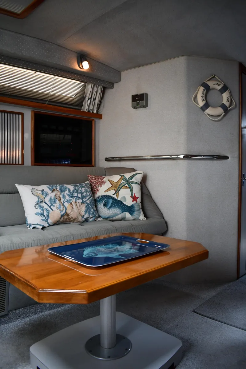 Slide: The Image of Interior of 1989 Sea Ray 390 Express Cruiser with cozy seating and nautical decor. - 42
