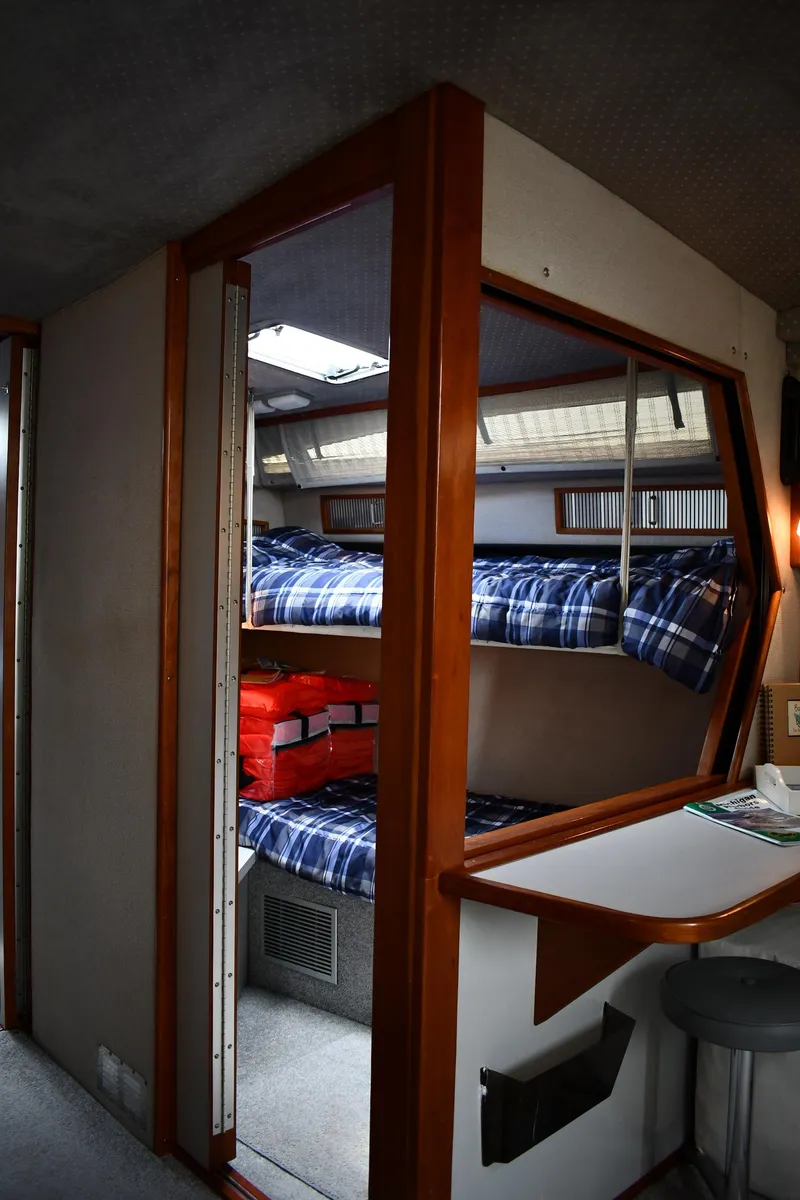 Slide: The Image of Interior of 1989 Sea Ray 390 Express Cruiser with bunk beds and seating area. - 47