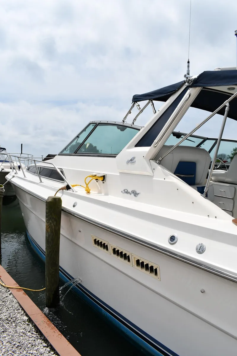Slide: The Image of 1989 Sea Ray 390 Express Cruiser docked at marina under cloudy sky. - 6