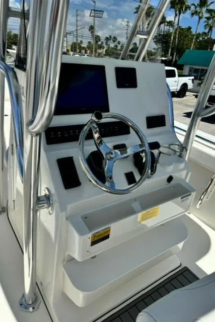 Slide: The Image of Steering console of 2026 Key West 239 FS boat with modern controls and display. - 11