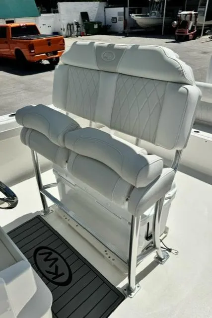 Slide: The Image of 2026 Key West 239 FS boat with white cushioned seating and stainless steel frame. - 13