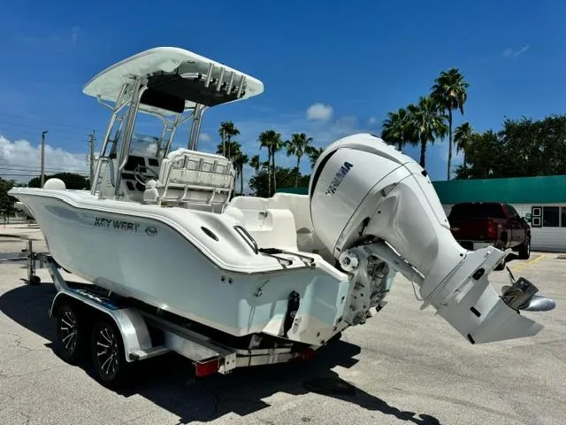 Slide: The Image of 2026 Key West 239 FS boat on trailer with Yamaha outboard, parked under clear blue sky. - 6