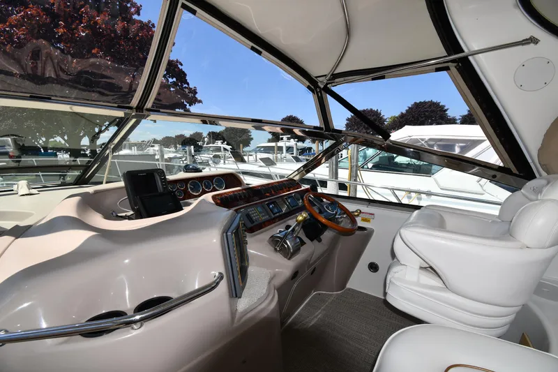 Slide: The Image of Interior view of 1997 Sea Ray 400 Sundancer yacht cockpit with steering wheel and controls. - 10