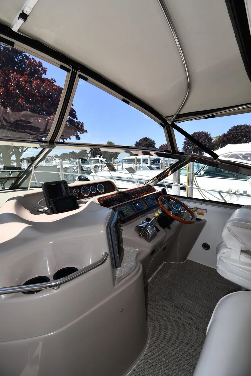 Slide: The Image of 1997 Sea Ray 400 Sundancer helm with modern controls and panoramic marina view. - 11