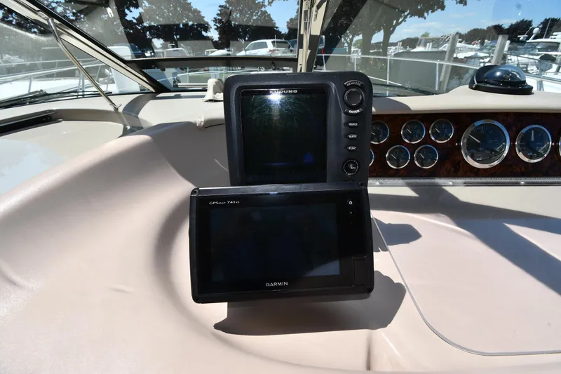 Slide: The Image of Dashboard of a 1997 Sea Ray 400 Sundancer with navigation equipment and gauges. - 12