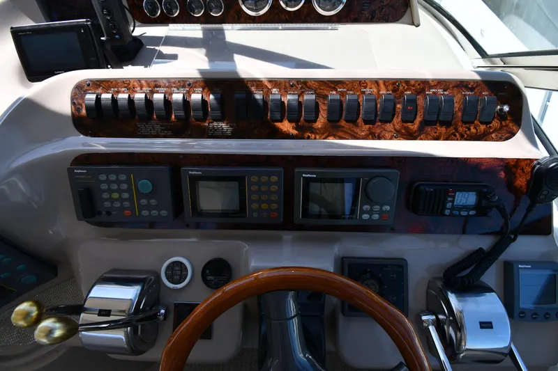 Slide: The Image of Control panel of a 1997 Sea Ray 400 Sundancer boat with navigation instruments. - 16