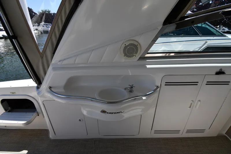 Slide: The Image of 1997 Sea Ray 400 Sundancer interior with sink and storage cabinets. - 27