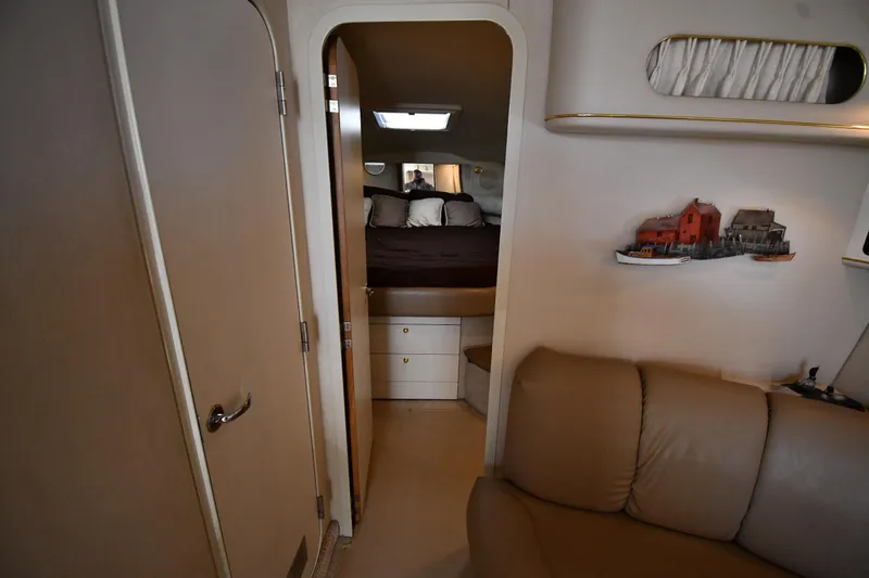 Slide: The Image of Interior of 1997 Sea Ray 400 Sundancer yacht, featuring cozy cabin and seating area. - 30
