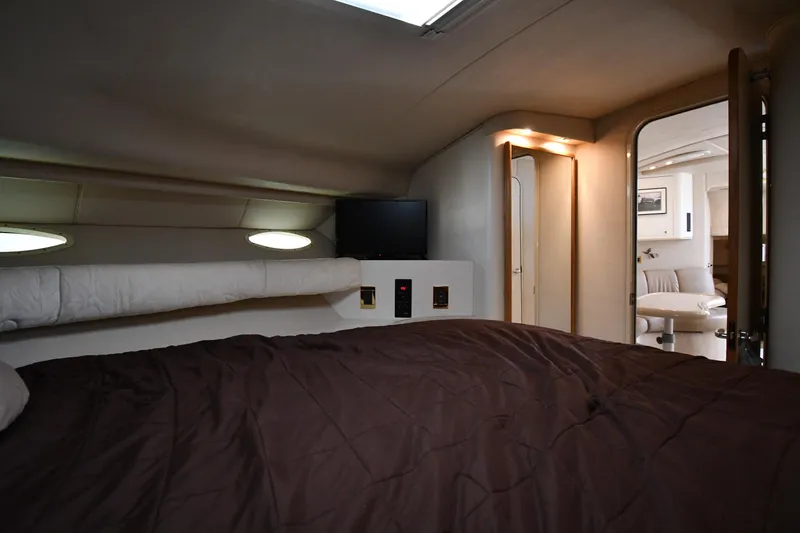 Slide: The Image of Interior cabin of 1997 Sea Ray 400 Sundancer yacht with bed and seating area. - 35
