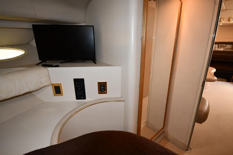 Slide: The Image of 1997 Sea Ray 400 Sundancer cabin interior with TV and control panel. - 36