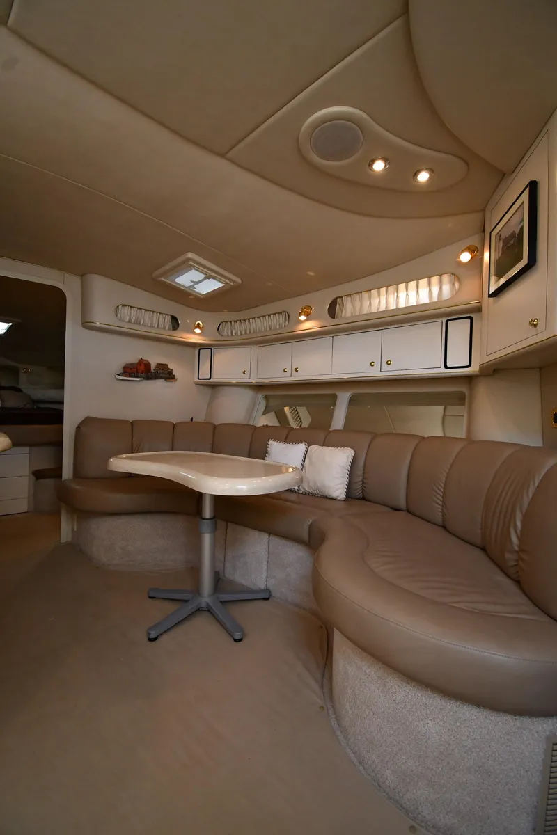 Slide: The Image of Interior of 1997 Sea Ray 400 Sundancer with curved seating and table. - 38