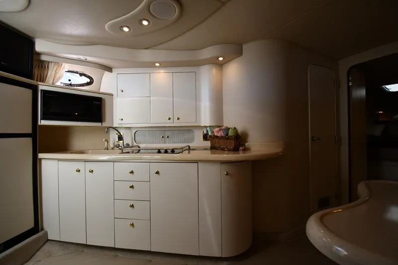 Slide: The Image of 1997 Sea Ray 400 Sundancer yacht interior kitchen with white cabinets and modern appliances. - 39