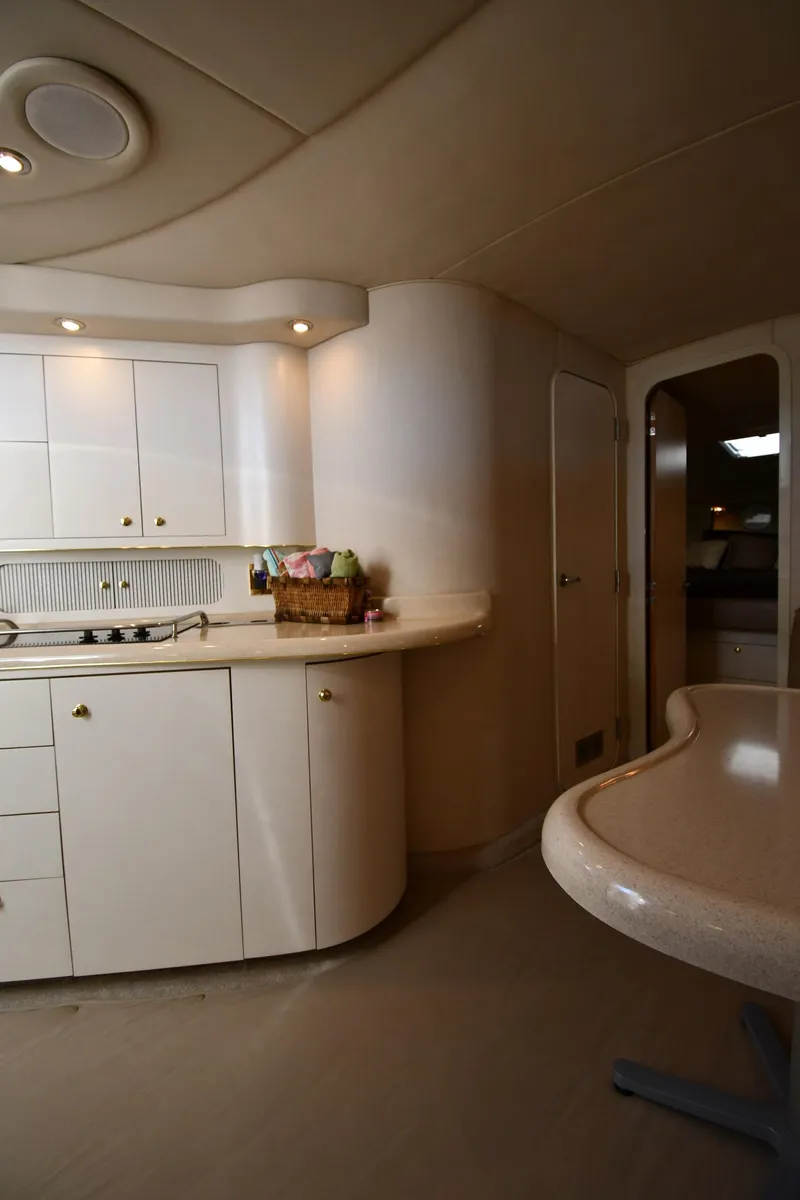 Slide: The Image of Interior of 1997 Sea Ray 400 Sundancer yacht, featuring a modern kitchen area. - 40