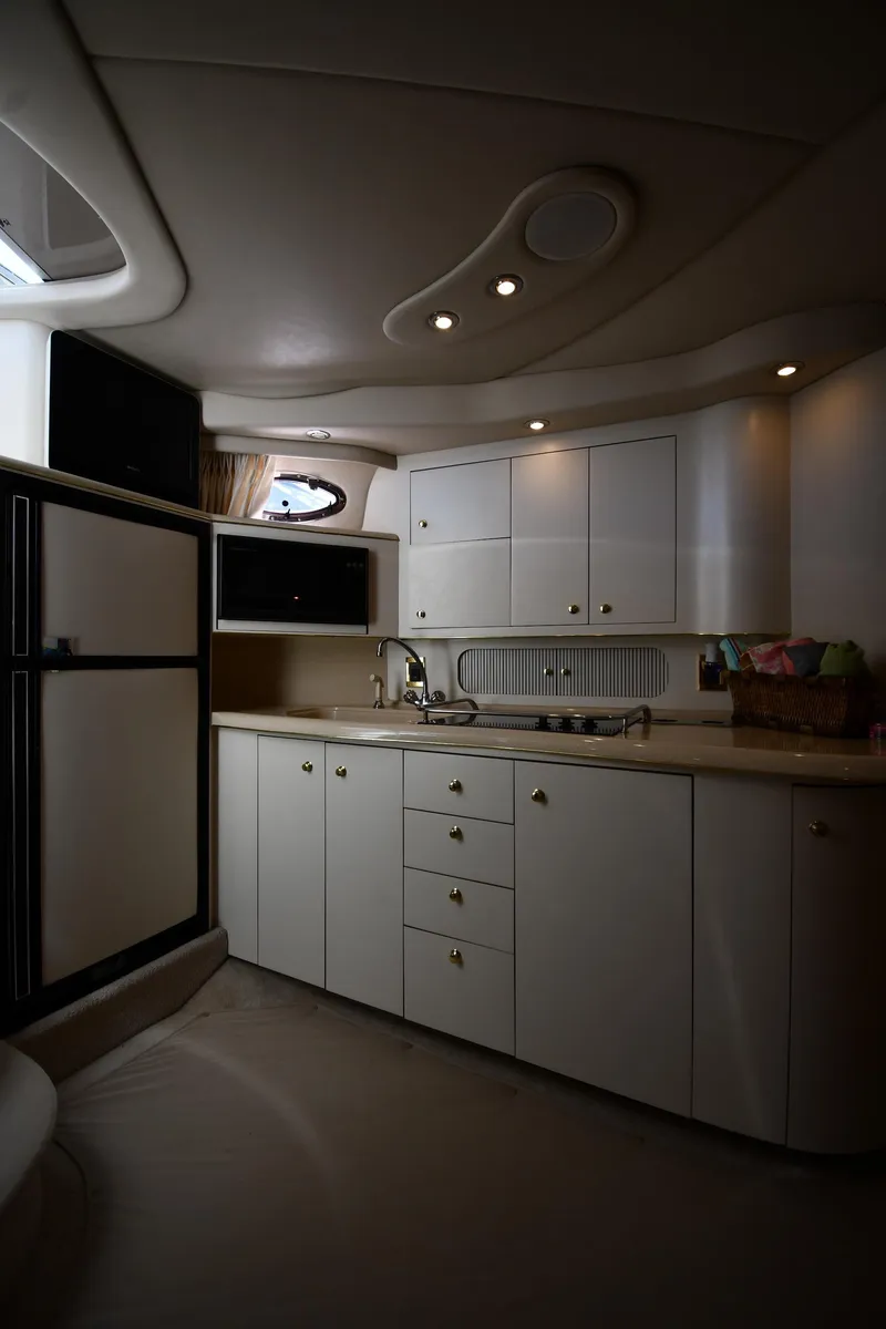 Slide: The Image of Interior of 1997 Sea Ray 400 Sundancer yacht kitchen with cabinets and appliances. - 41