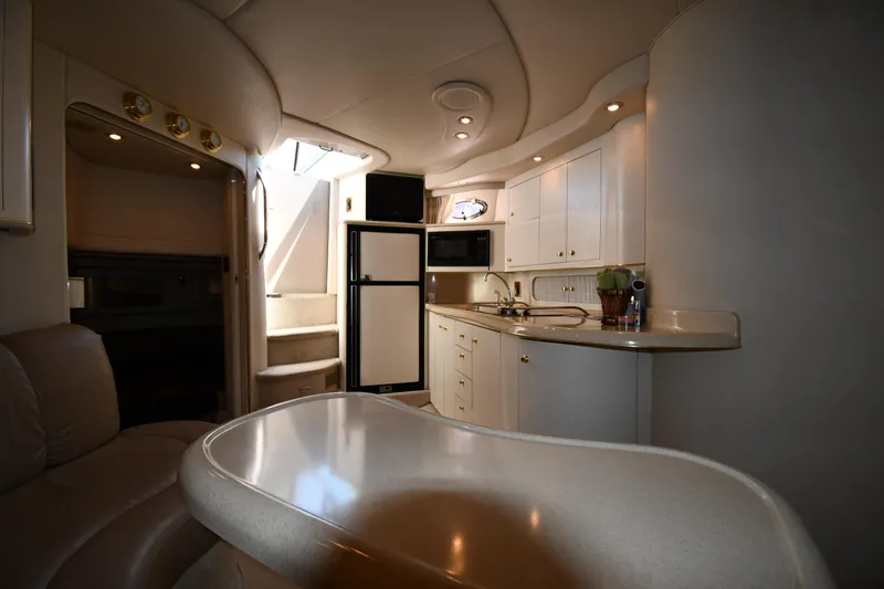 Slide: The Image of Interior of 1997 Sea Ray 400 Sundancer yacht, featuring a modern kitchen and seating area. - 42